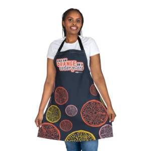 Woman holding up a NCJW apron
